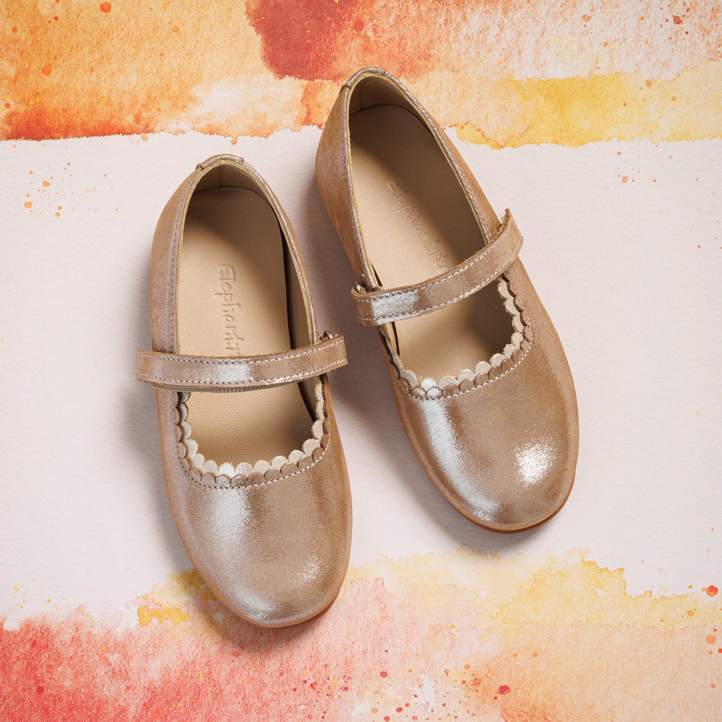 Blush pink toddler Mary Jane shoes with scalloped edge and velcro strap closure.