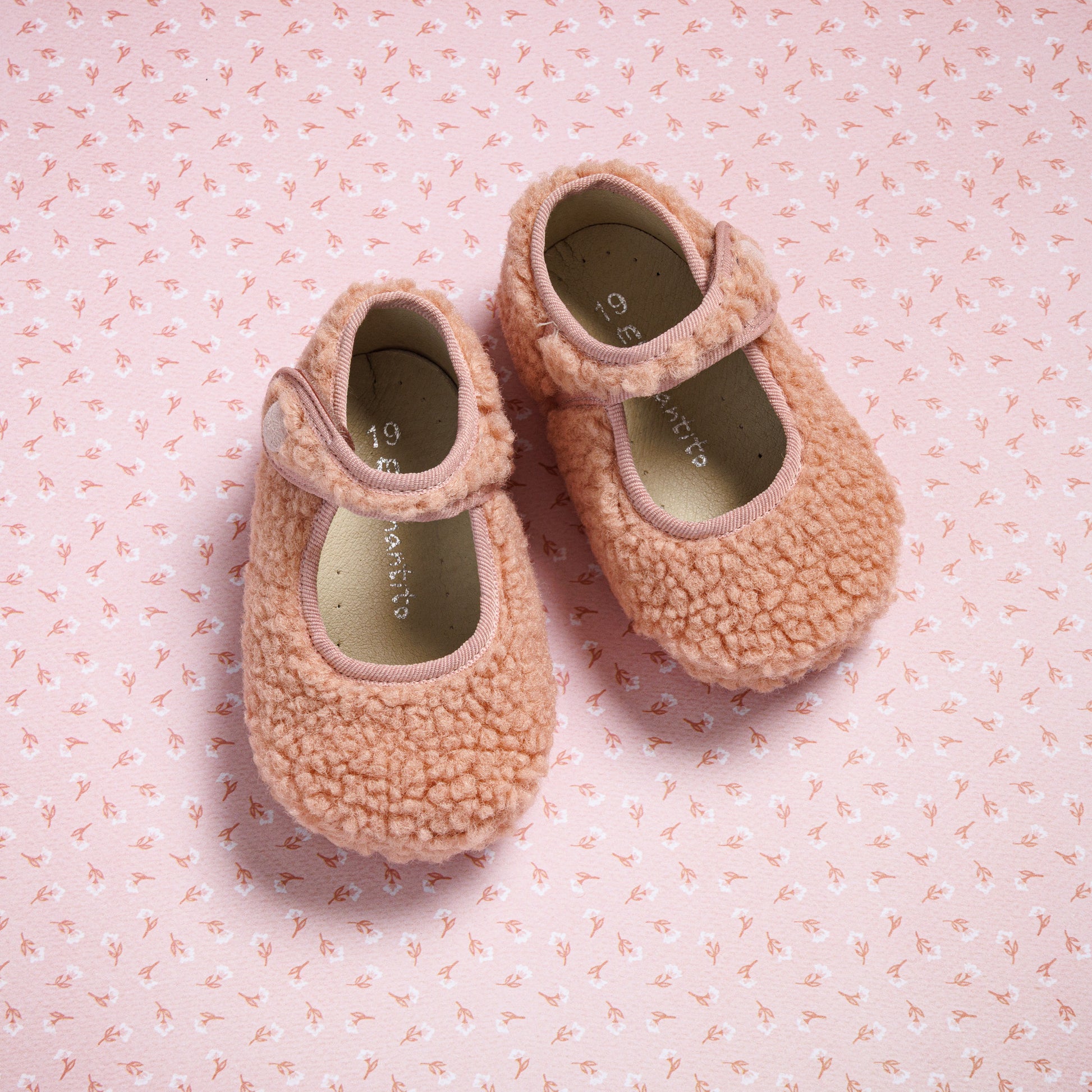 Pink shearling baby Mary Jane shoes with adjustable straps and soft cushioned insoles.