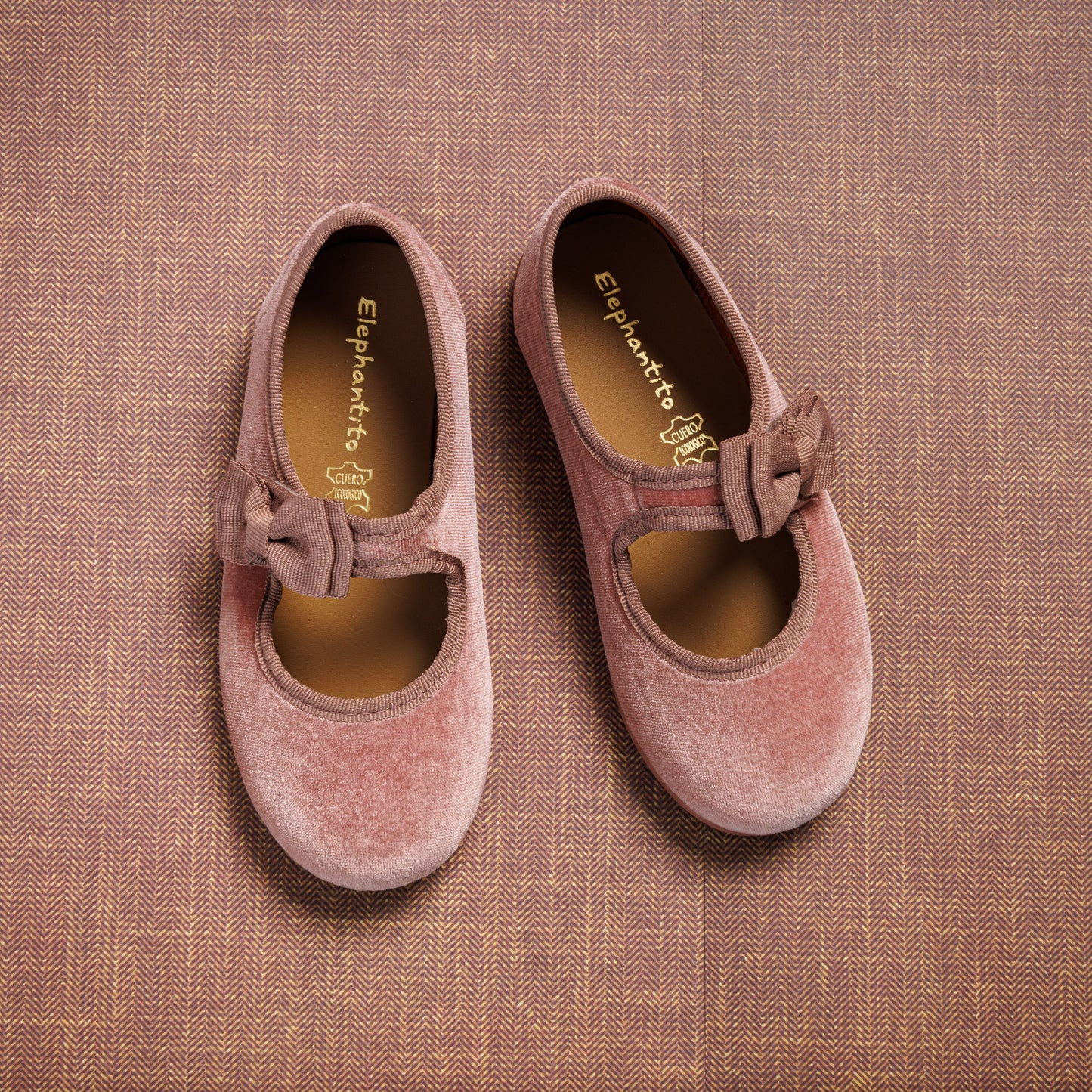 Pink velvet Mary Jane shoes with side bows, rounded toes, and soft cushioned insoles.