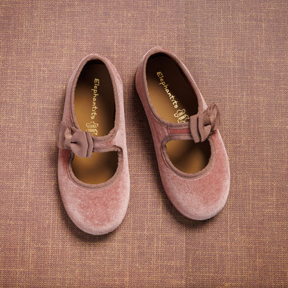 Pink velvet Mary Jane shoes with side bows, rounded toes, and soft cushioned insoles.