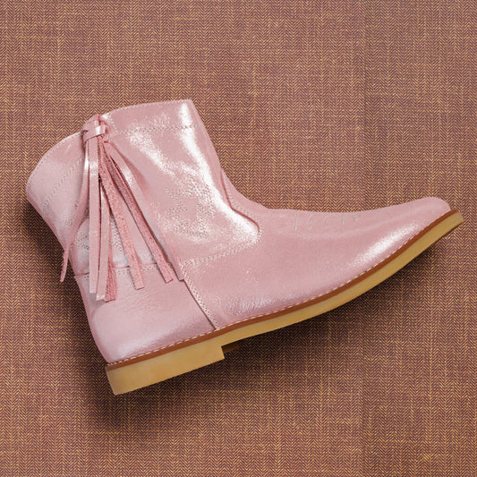 Pink metallic suede ankle boot with tassel detail and tan flat sole for kids.