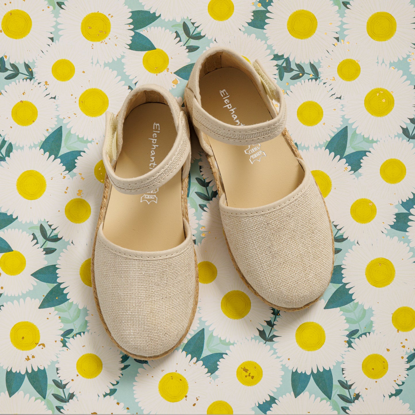 Elephantito - Toddler-size white linen espadrille shoes with a metallic finish and a strap across the ankle.