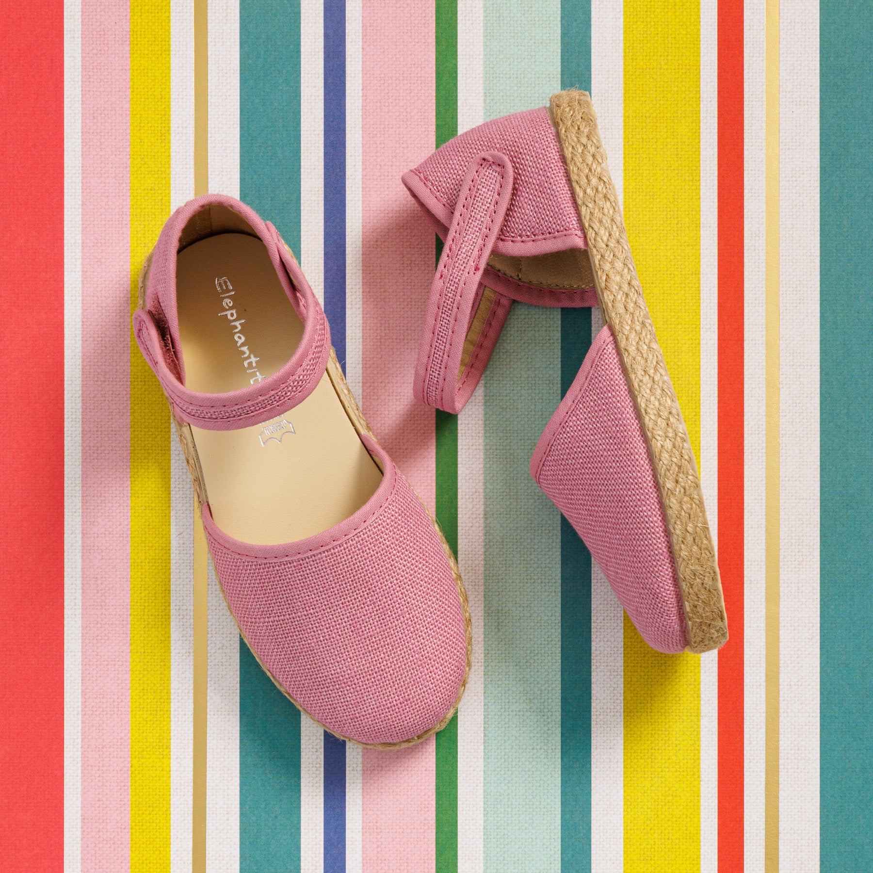 Elephantito - Mauve linen espadrille for girls with jute sole and Velcro strap on colorful striped background.