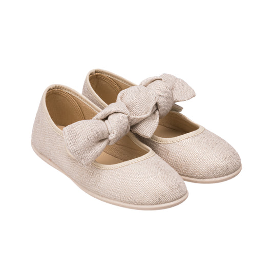 Beige linen Mary Jane shoes with large bows and rounded toes for toddlers.