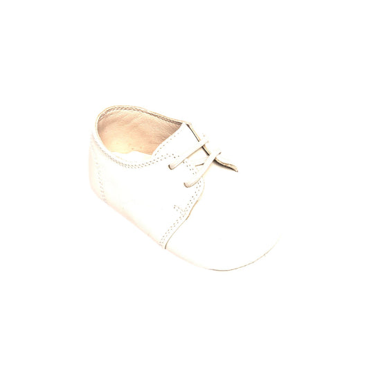 Soft white baby oxford shoe with lace-up closure and smooth leather material.