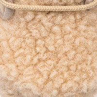 Beige shearling baby bootie with soft, curly wool texture and stitched trim detail.
