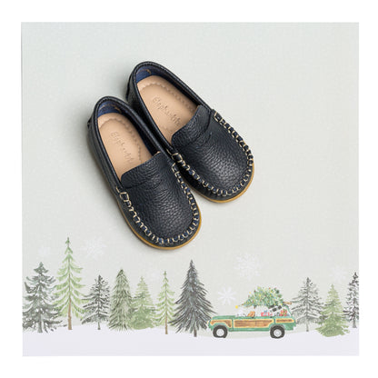 Navy blue boys loafers with textured leather and moccasin stitching on brown soles.