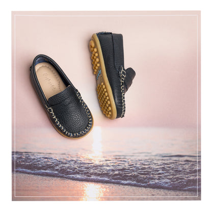 Navy blue boys' leather loafers with stitched detailing and rubber pebble sole.