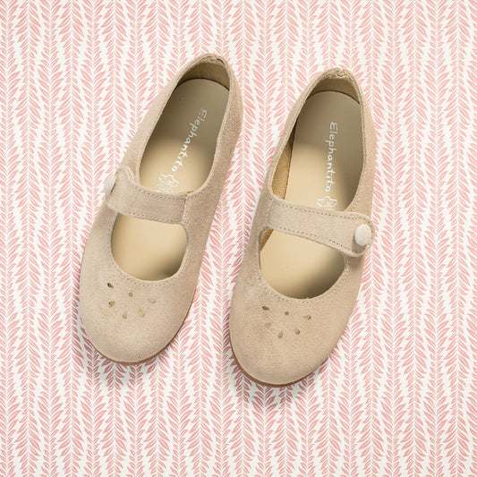 Beige suede Mary Jane shoes for toddlers with button strap and perforated toe design.