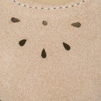 Beige suede Mary Jane shoe with teardrop-shaped perforations and white stitching detail.