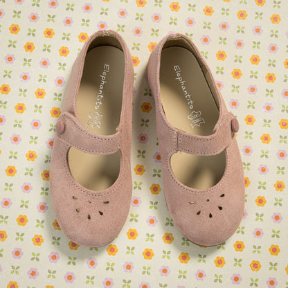 Pink suede Mary Jane shoes for toddlers with scalloped edges and perforated flower details.