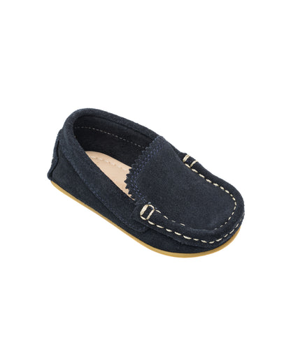 Navy blue suede toddler moccasin with white stitching and soft sole.