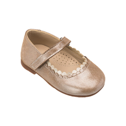 Blush pink toddler flat shoe with scalloped edges and a single velcro strap closure.