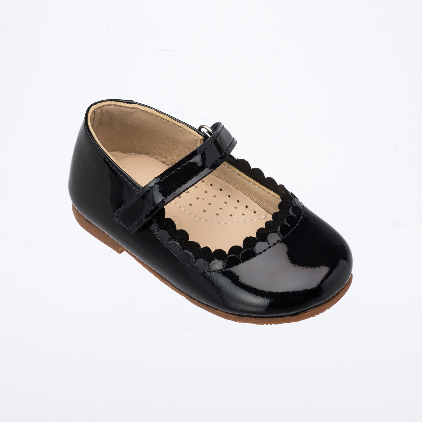 Black patent leather toddler Mary Jane shoe with scalloped edge and Velcro strap.