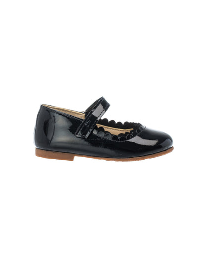Black patent leather toddler Mary Jane shoe with scalloped edges and Velcro strap.