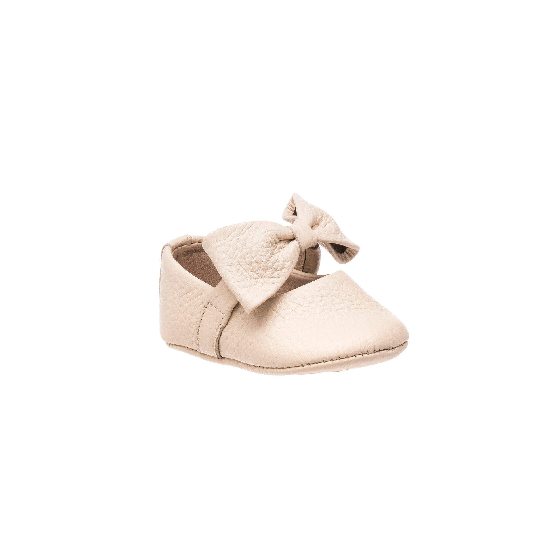 Cream baby ballerina shoe with textured bow and soft sole.