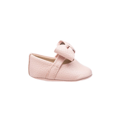 Soft pink baby ballerina shoe with textured material and a large decorative bow on top.
