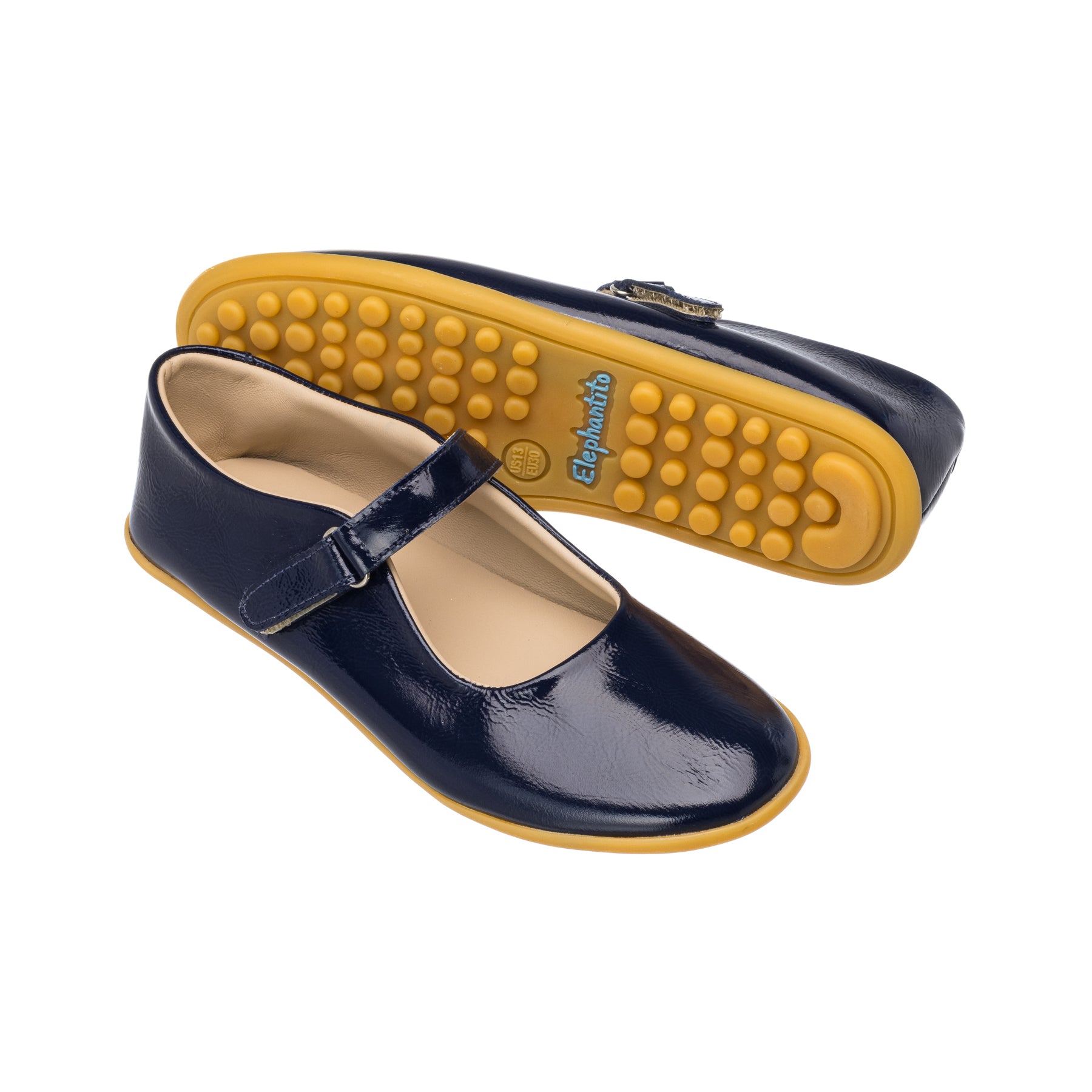 Glossy navy blue toddler Mary Jane shoes with yellow flexible rubber soles and adjustable strap buckle.