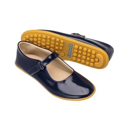 Glossy navy blue toddler Mary Jane shoes with yellow flexible rubber soles and adjustable strap buckle.