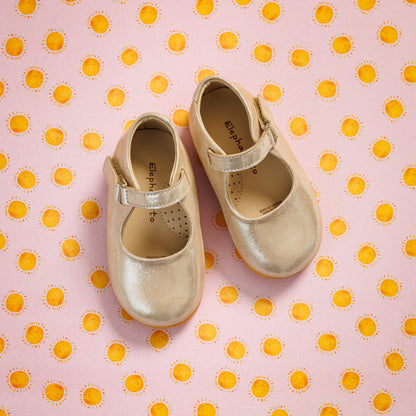 Elephantito - Creamy beige toddler Mary Jane shoes with a single strap, subtle perforated details, on pink polka-dot background.
