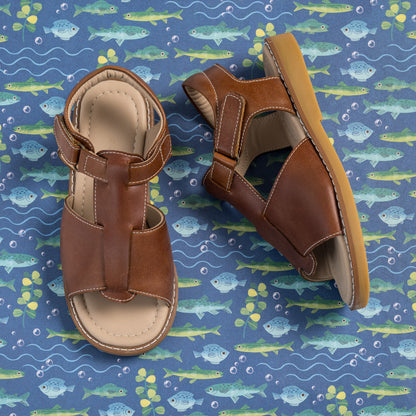Brown leather toddler sandals with adjustable ankle straps and cushioned insoles.