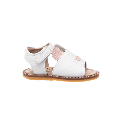 White toddler sandal with pink bunny ear detail and tan rubber sole.