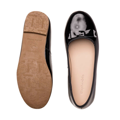 Black patent leather toddler ballerina flats with rounded toe and textured tan sole.