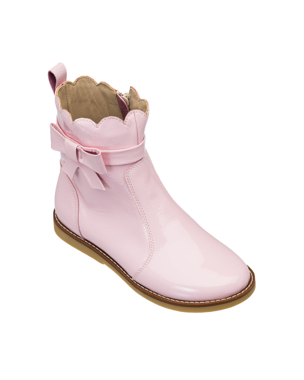 Pink glossy toddler bootie with scalloped top edge and decorative bow on side, tan sole.