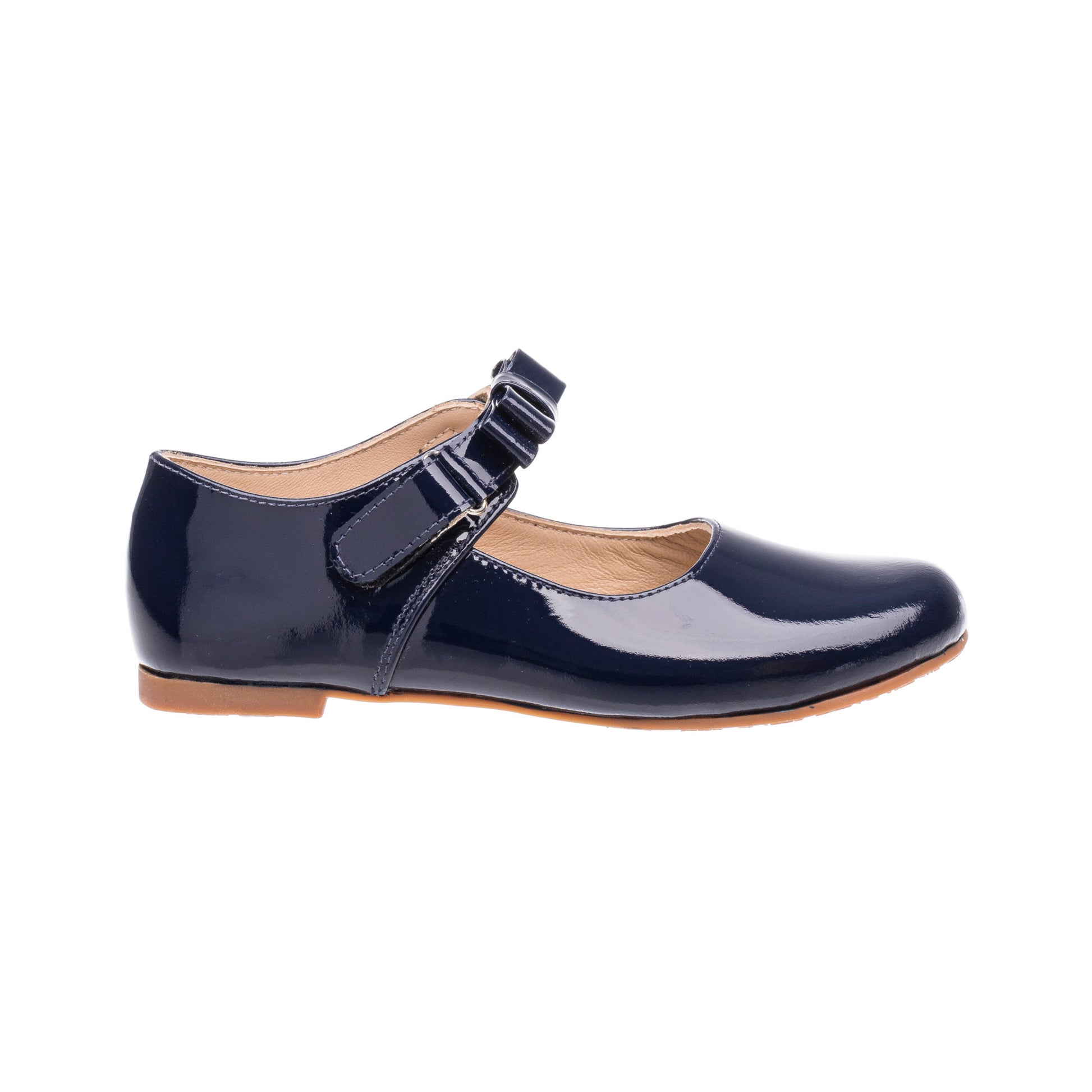Navy blue patent leather girls Mary Jane shoe with buckle strap and tan sole.