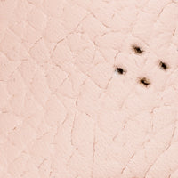 Pink toddler sandal with quilted scallop pattern and small perforations.