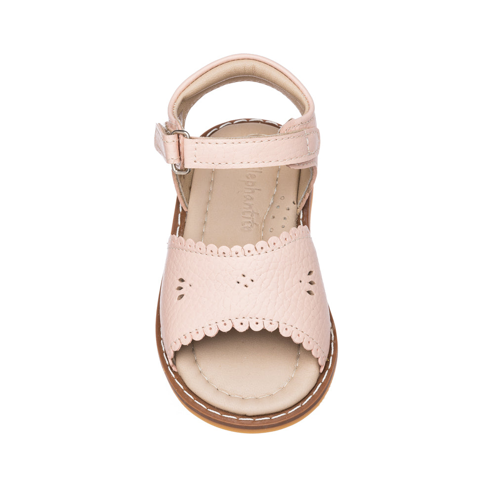 Pink toddler sandal with scalloped edges and ankle strap on tan sole.