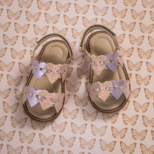 Toddler sandals with pink and lavender butterfly straps on tan footbed and sole.