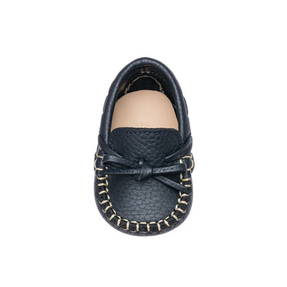 Navy blue baby loafer with textured leather, decorative bow, and contrast stitching.