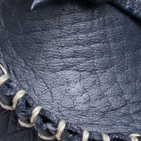 Close-up of navy blue leather driver loafer with tan hand-stitched detailing on the toe area.