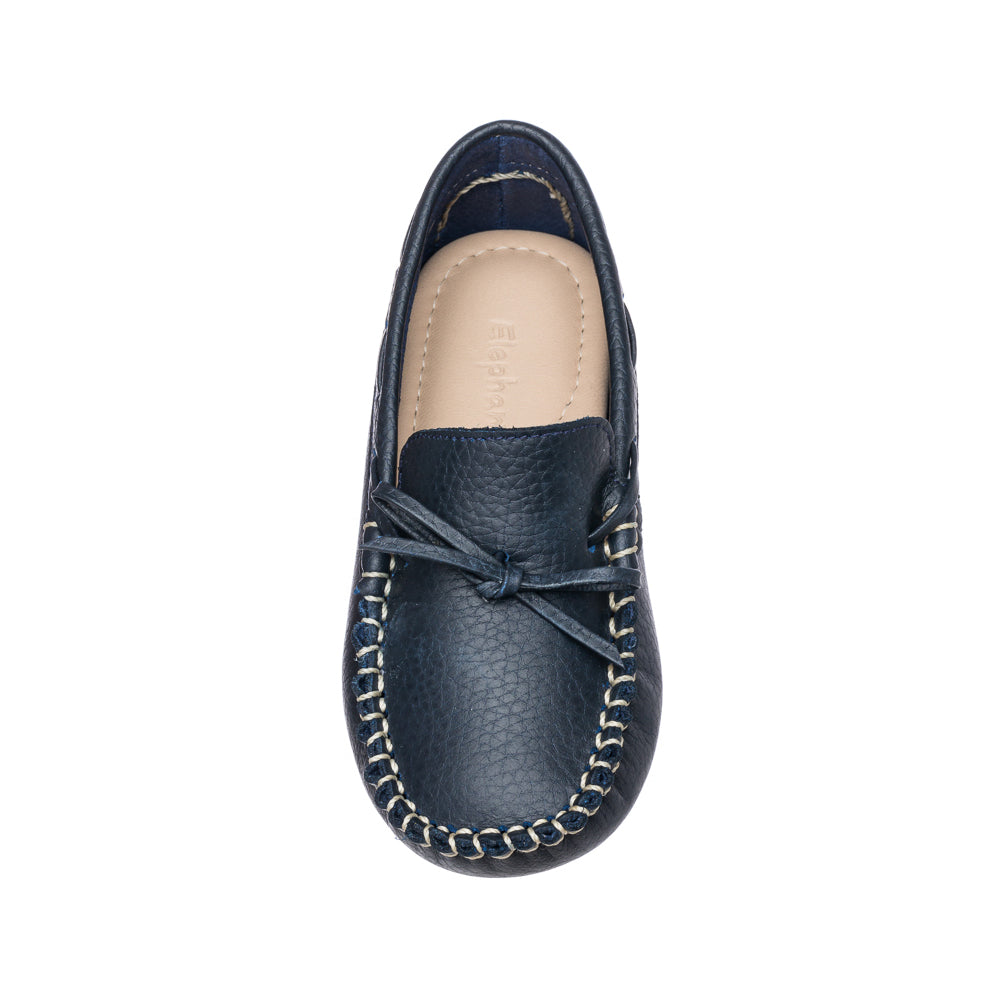 Navy blue leather boys' driver loafer with moccasin-style stitching and bow detail.