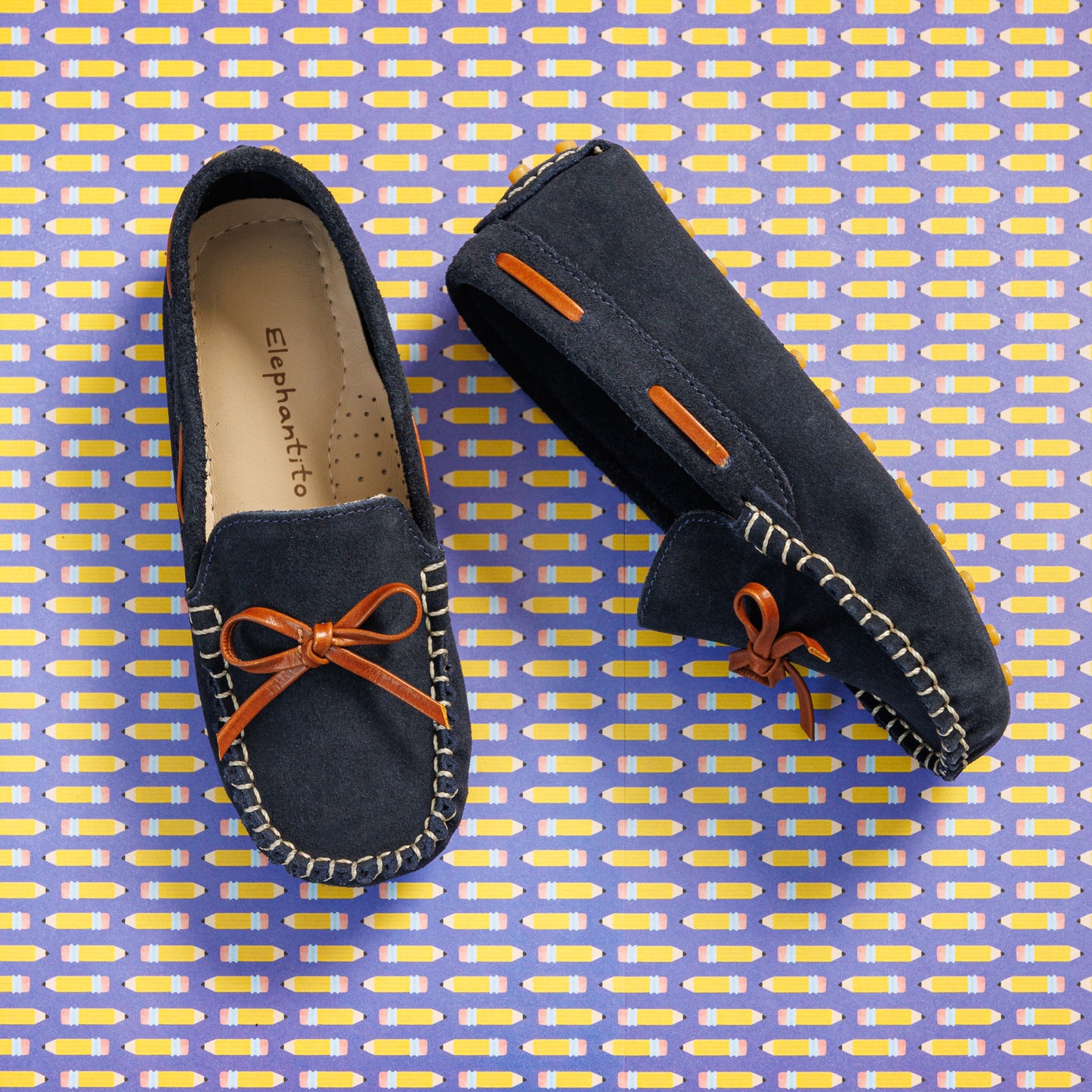 Elephantito - Blue suede boys' driver loafers with orange lace bow and white stitching detailing.