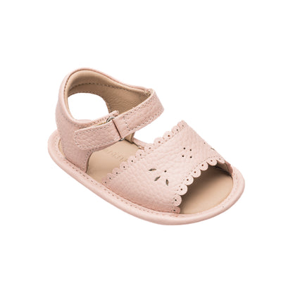 Pink toddler sandal with scalloped edges and perforated floral details, adjustable ankle strap.