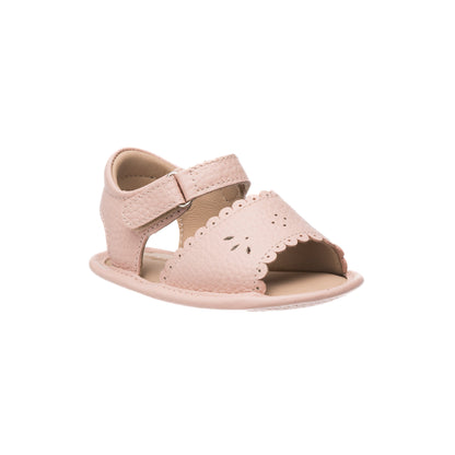 Pink toddler sandal with scalloped edges and perforated floral design, adjustable velcro strap.