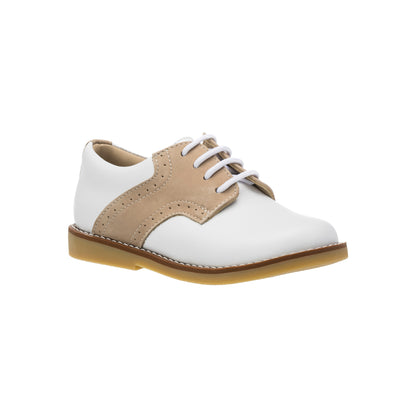 White and ivory toddler shoe with beige brogue detailing and white laces on a gum sole.