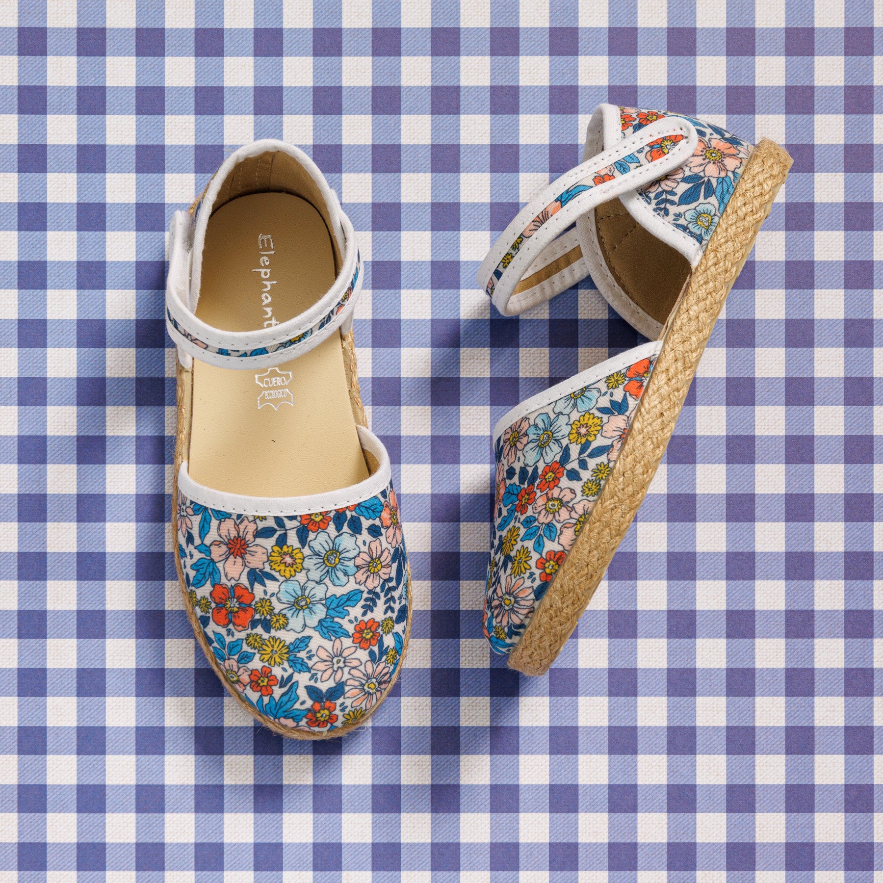 Elephantito - Girls' floral linen espadrille sandals with ankle strap and jute sole on blue gingham background.