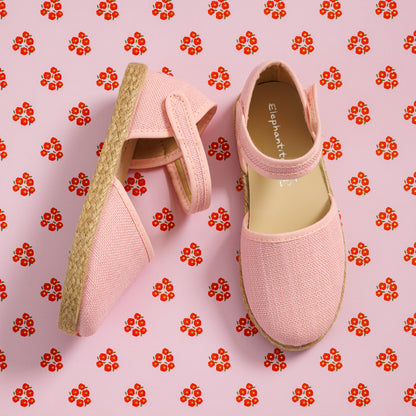 Elephantito - Pink linen espadrille with ankle strap and jute sole on floral background.