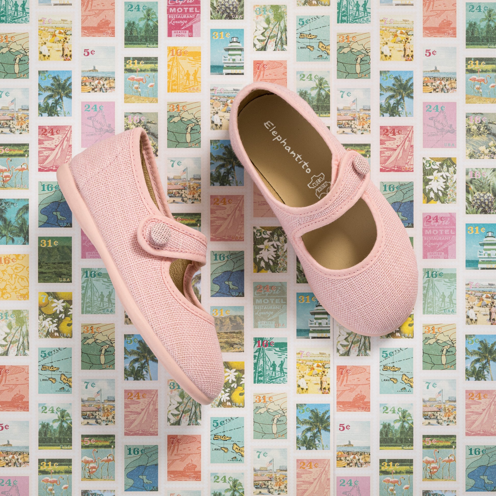 Pink linen Mary Jane toddler shoes with round toes and button strap closures.
