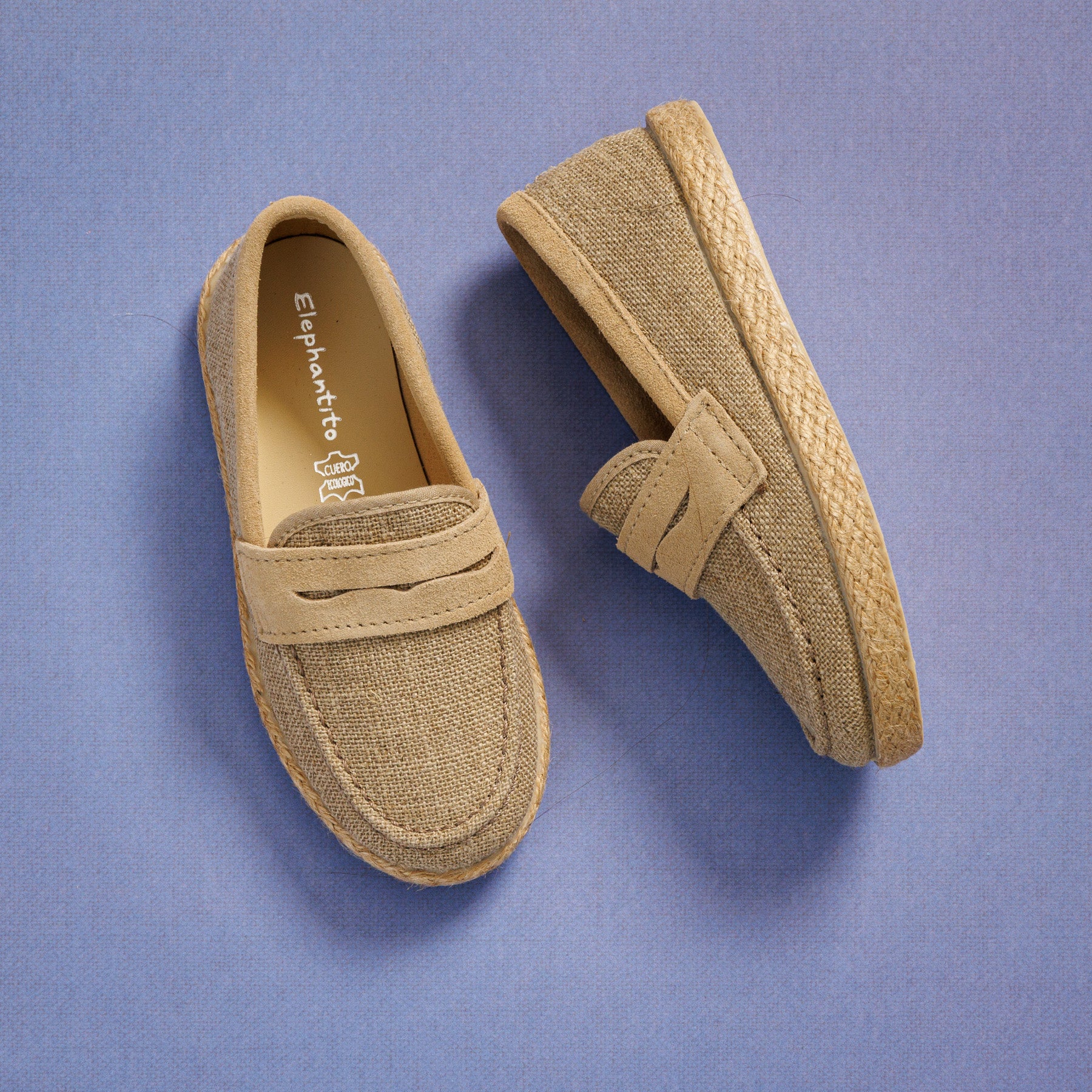 Elephantito - Beige toddler loafer espadrilles with textured fabric and braided jute sole on purple background.
