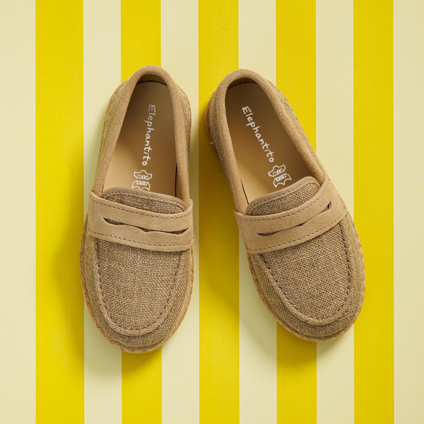 Elephantito - Beige boys loafer espadrilles with stitched detailing and textured fabric upper on yellow striped background.