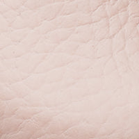 Soft pink textured leather close-up with subtle natural grain detail.