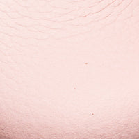 Soft pink leather texture with subtle grain detail.
