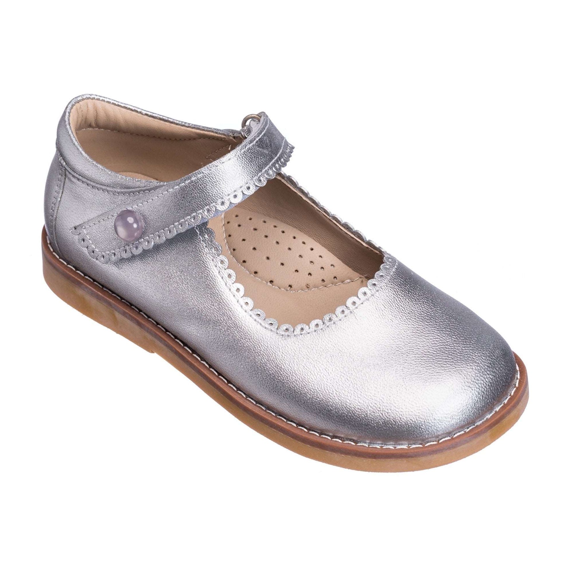 Silver metallic leather Mary Jane shoe with scalloped edges and Velcro strap for toddlers.
