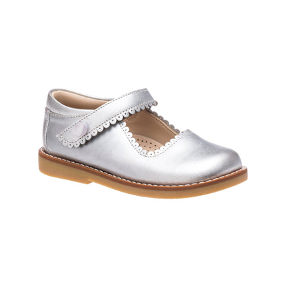 Silver leather Mary Jane shoe with scalloped edge and velcro strap, tan sole.