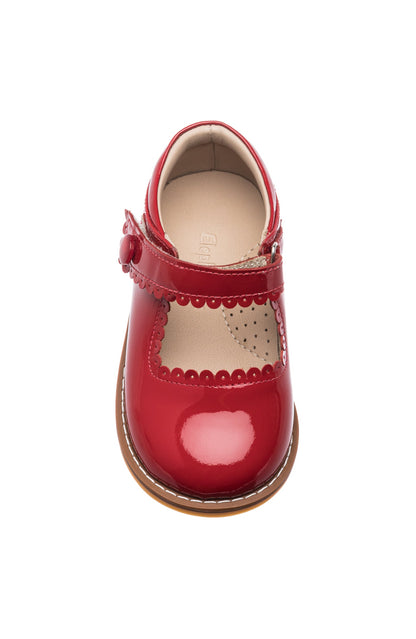 Red patent leather toddler Mary Jane shoe with scalloped edges and adjustable strap.