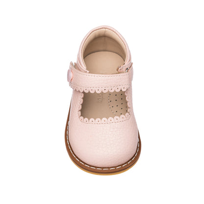 Pink toddler Mary Jane shoe with scalloped edges and velcro strap closure.